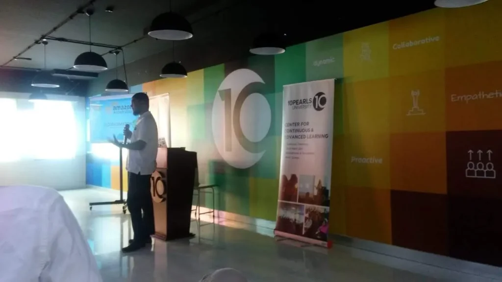 Speaker presenting in a corporate training hall, 2017