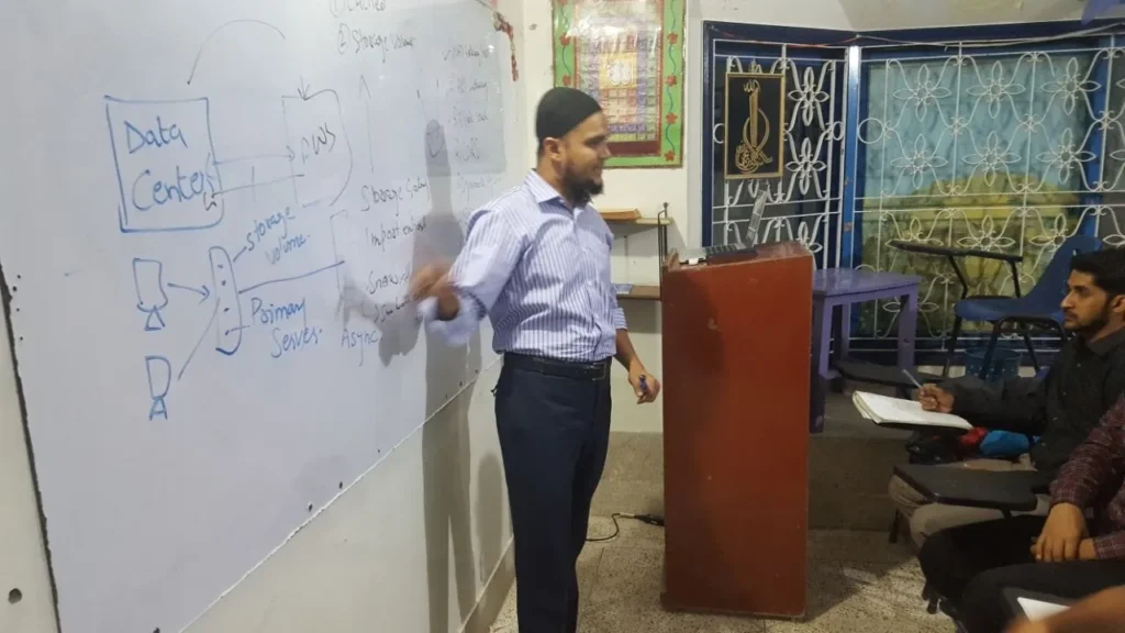 Instructor drawing a cloud architecture diagram on the whiteboard, 2017