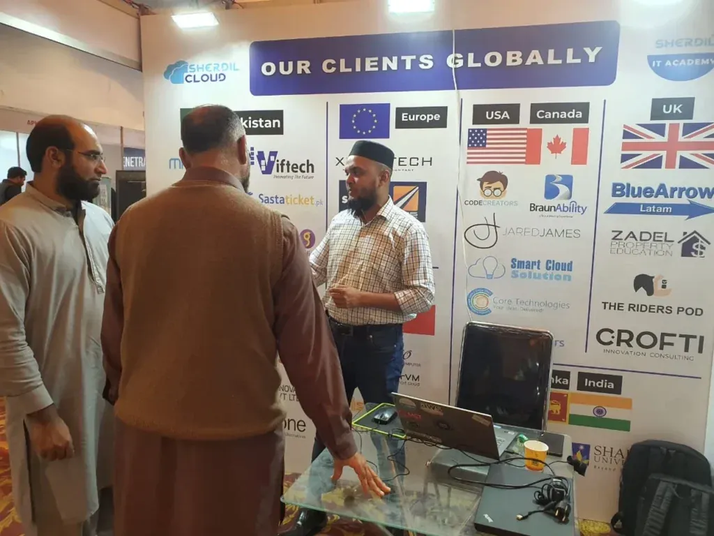 Visitors at the Sherdil booth in front of the Our Clients Globally wall, ITCN Asia 2023