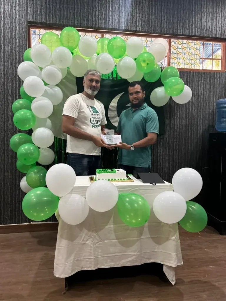 Team member receiving a gift envelope at the Sherdil Independence Day celebration 2023