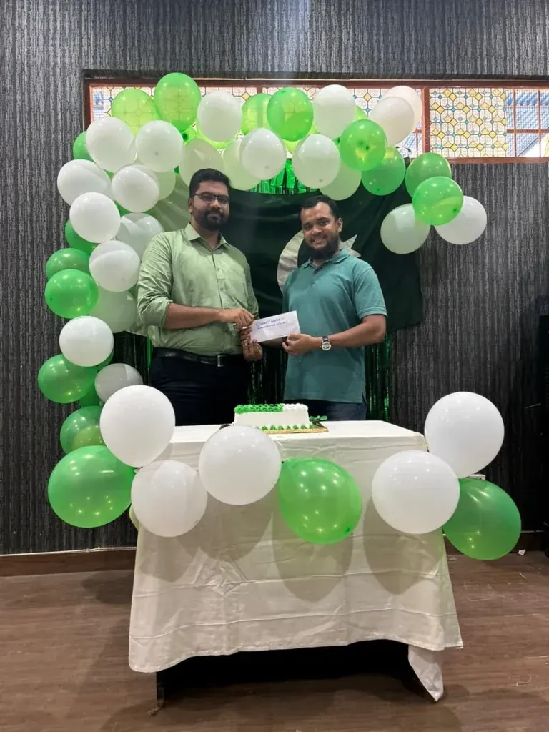 Two colleagues at the Independence Day balloon arch, Sherdil 2023