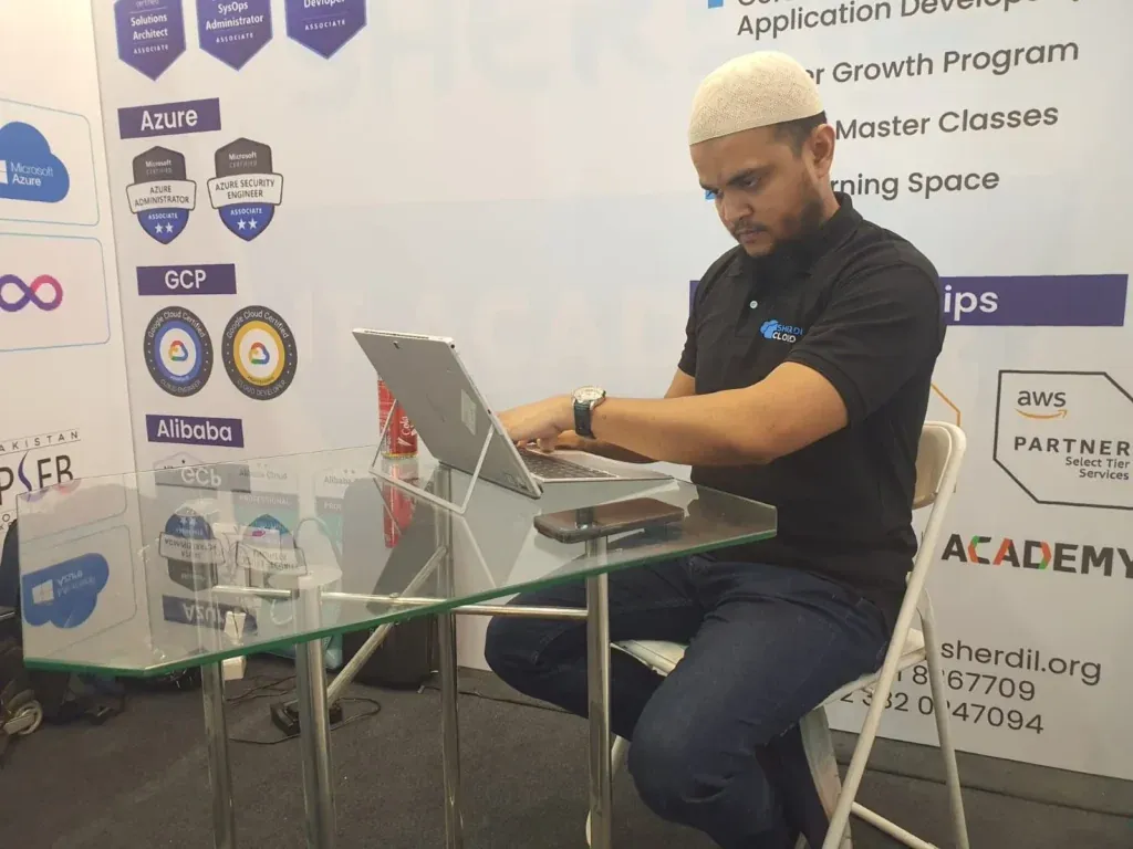Sherdil team member working on a laptop at the booth, ITCN Asia 2024 Lahore