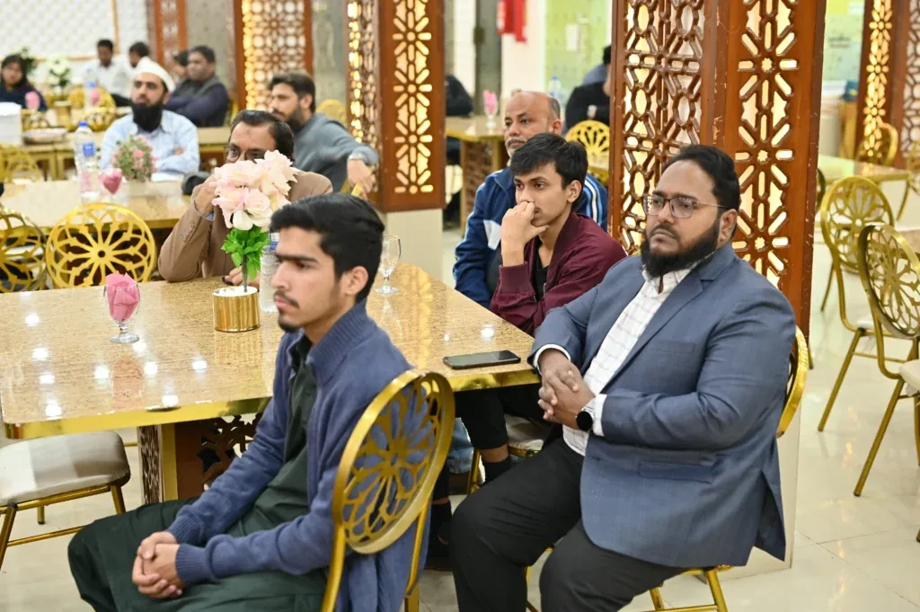 Students and alumni seated at tables, Sherdil 7th anniversary meetup 2024