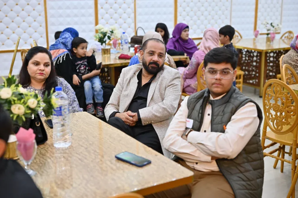 Families and students at tables, Sherdil 7th anniversary meetup 2024