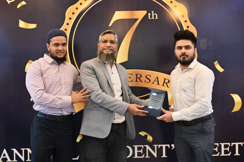 Award handover in front of the 7th anniversary backdrop, Sherdil IT Academy 2024