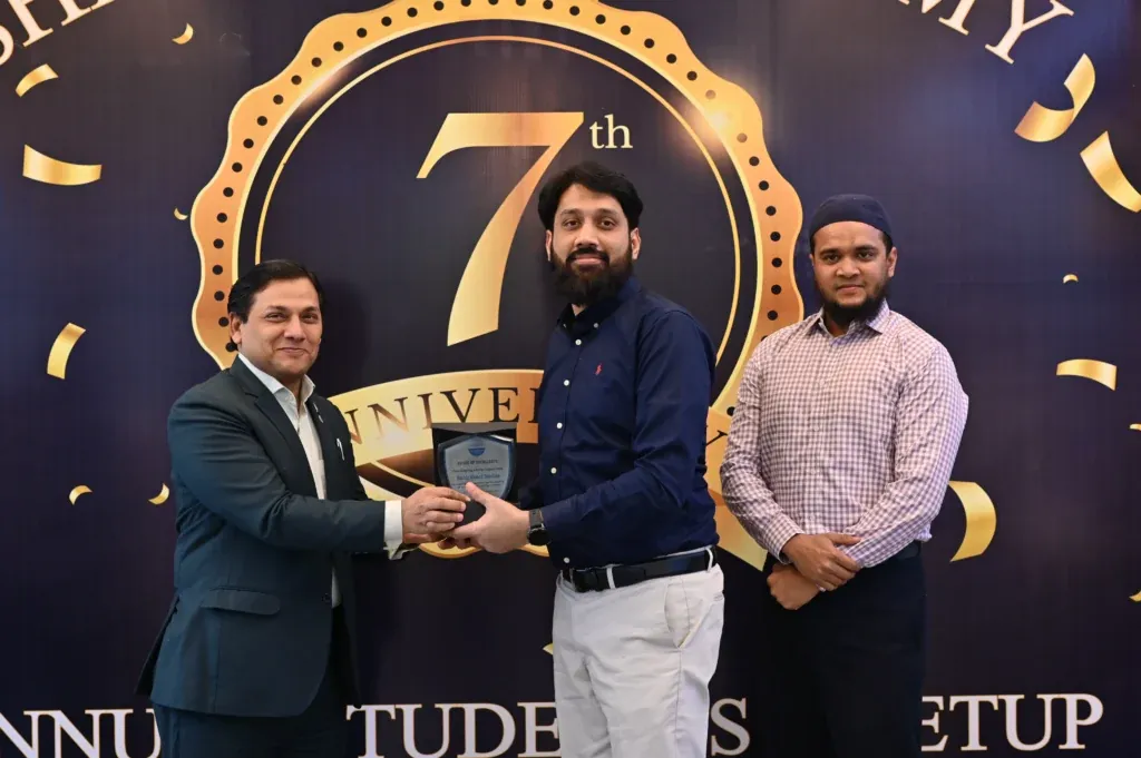 Guest presenting an award on stage, Sherdil 7th Anniversary Meetup 2024