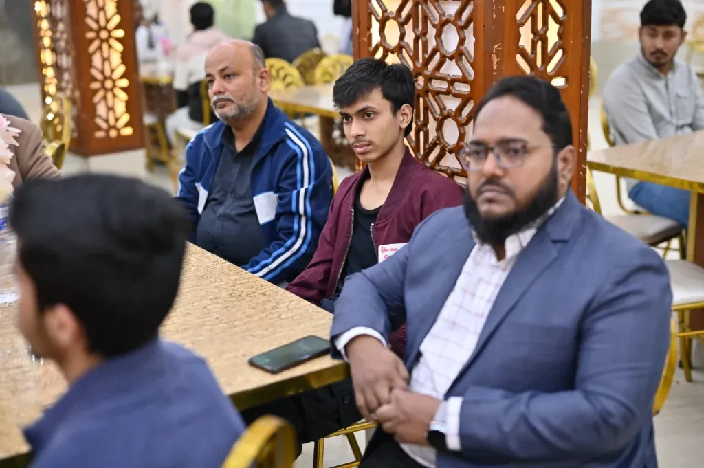 Attendees seated at tables during the Sherdil 7th anniversary meetup, 2024