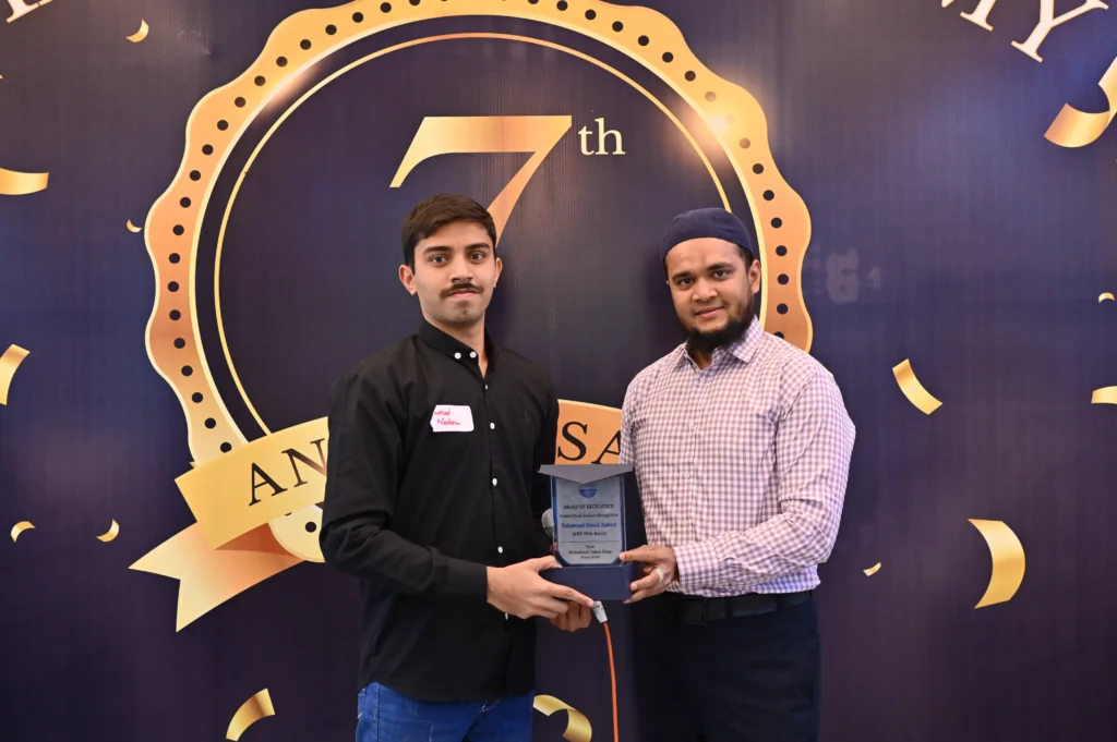 Student receiving an award on stage, Sherdil 7th anniversary 2024
