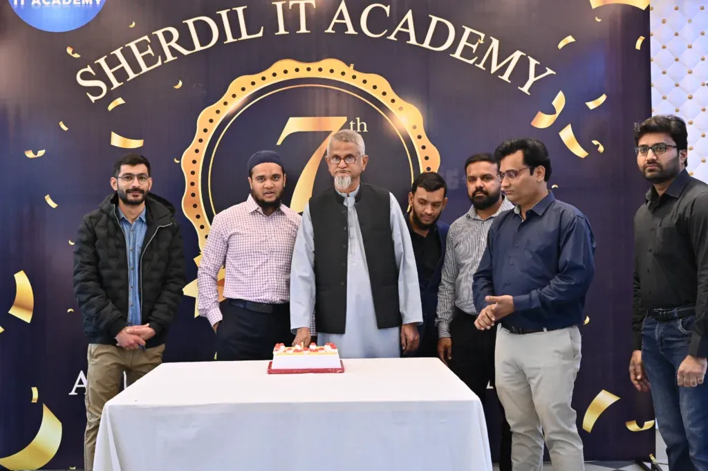 Sherdil team and guests around the anniversary cake, 2024