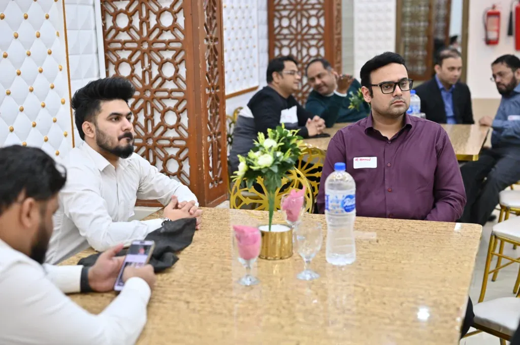 Alumni talking at a table, Sherdil 7th anniversary meetup 2024