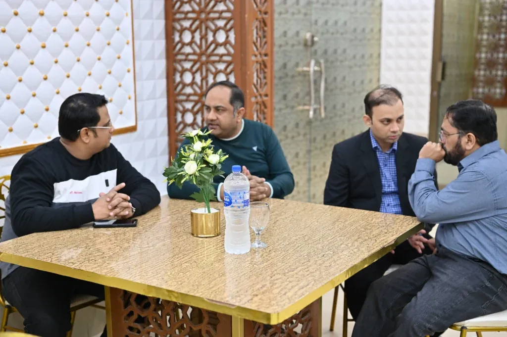 Guests in conversation at a table, Sherdil 7th Anniversary Meetup 2024