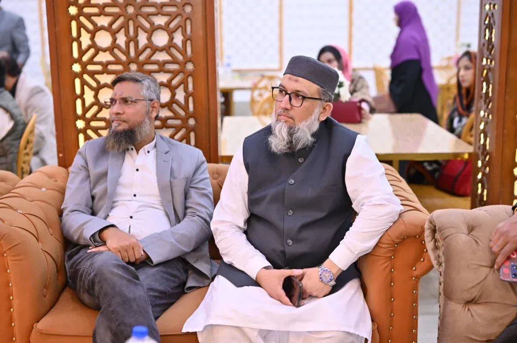 Two guests seated on a sofa at the Sherdil 7th anniversary meetup, 2024