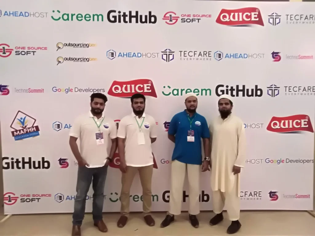 Sherdil team in front of the event sponsors wall, 2019
