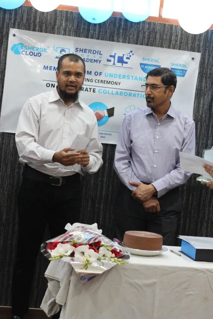 Two guests beside the cake table, Sherdil Cloud MOU ceremony 2022