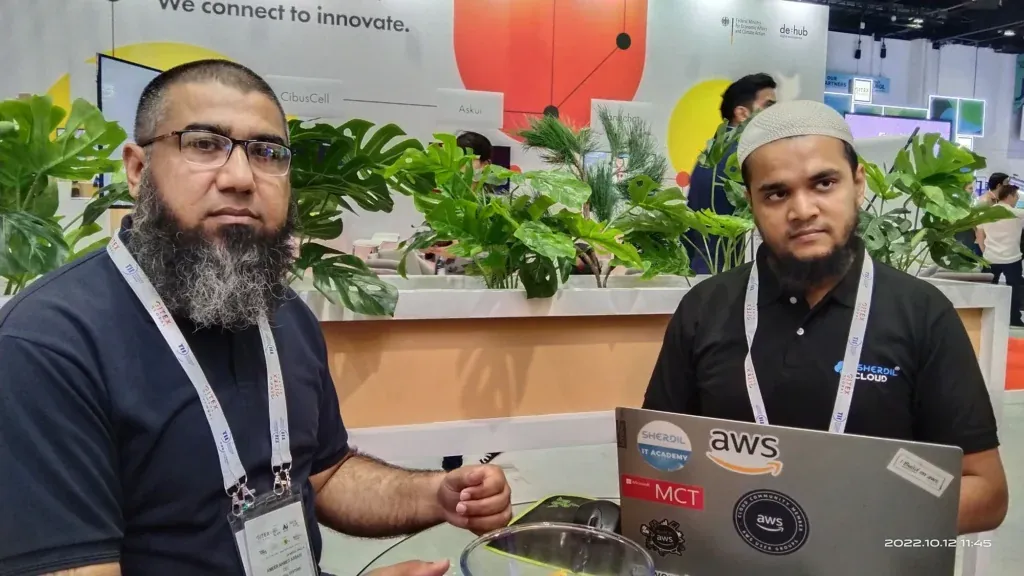 Sherdil team members working on laptops at GITEX Dubai 2022