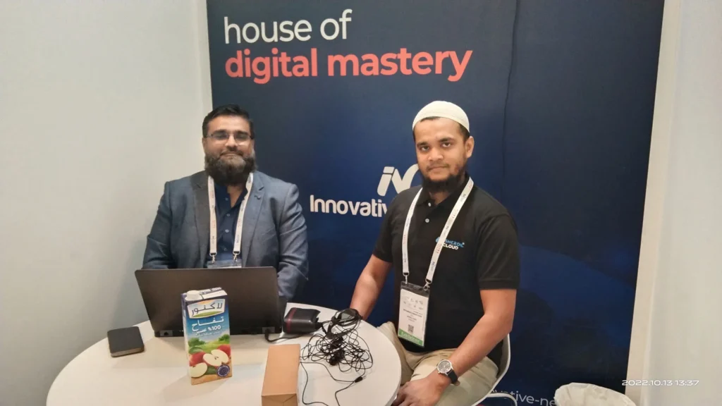 Two Sherdil team members at a meeting table, GITEX Dubai 2022