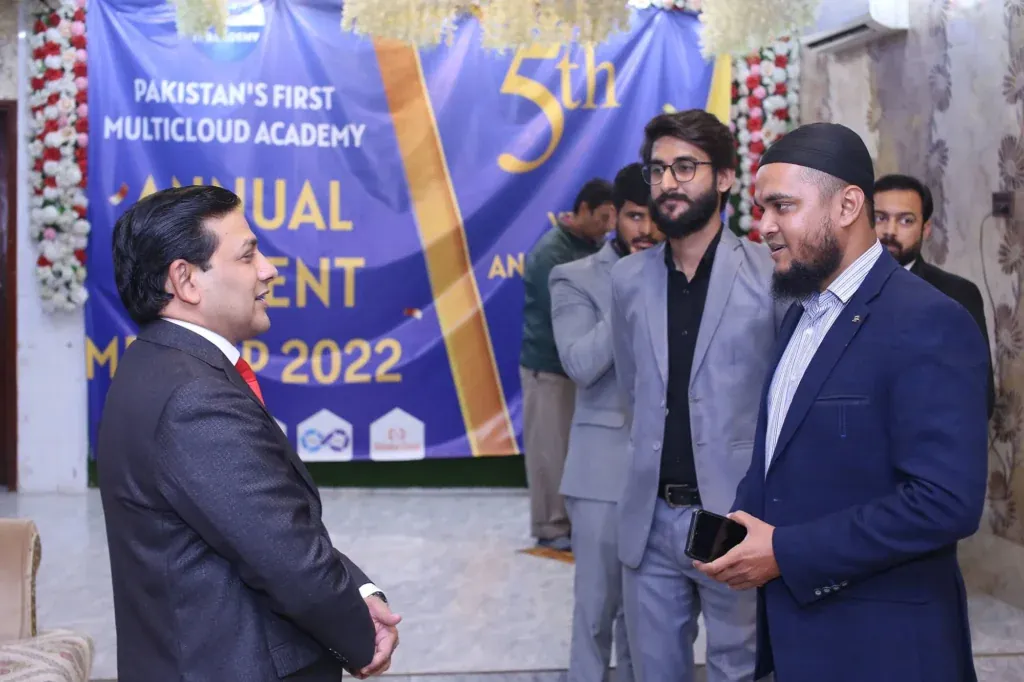 Guests talking in front of the 5th anniversary banner, Sherdil 2022