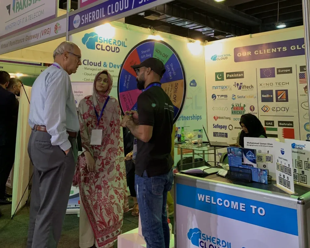 Welcome counter of the Sherdil Cloud booth with visitors, ITCN Asia 2025