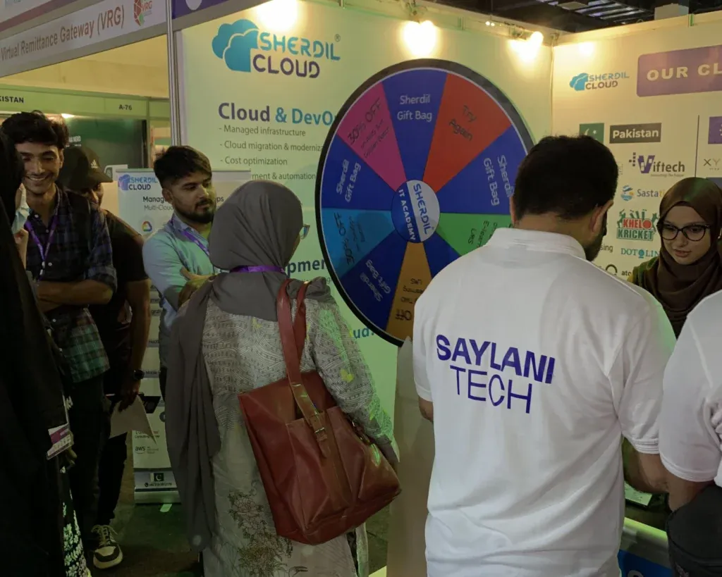 Visitors trying the prize wheel at the Sherdil Cloud booth, ITCN Asia 2025