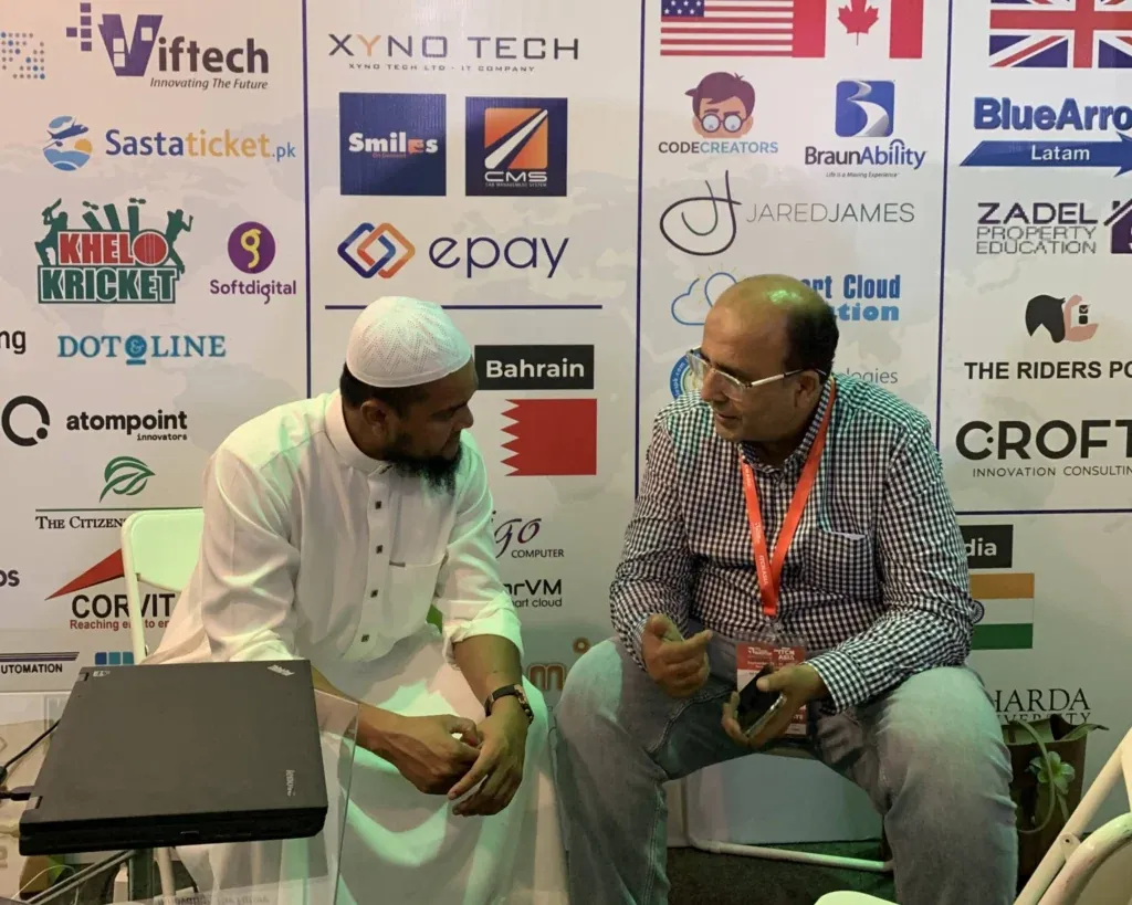 Two guests in discussion at the Sherdil booth, ITCN Asia 2025