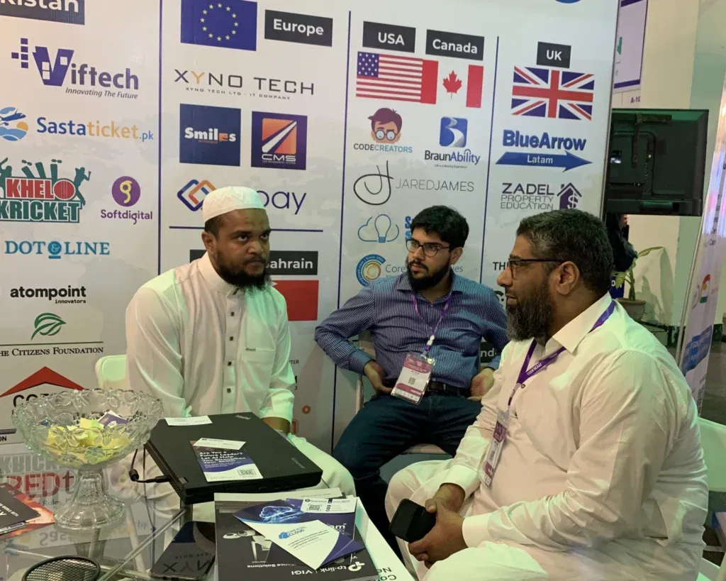 Seated discussion in front of the Sherdil client logo wall, ITCN Asia 2025