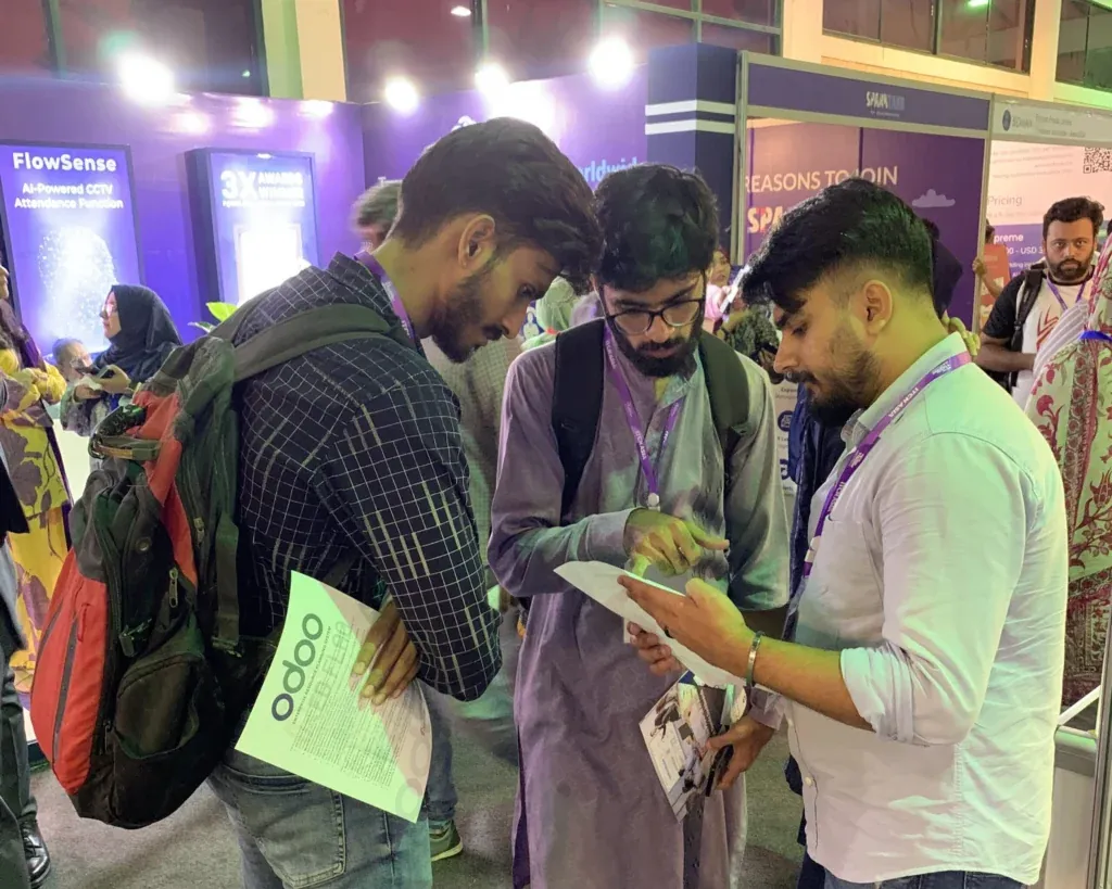 Visitors looking at a phone at the Sherdil booth, ITCN Asia 2025