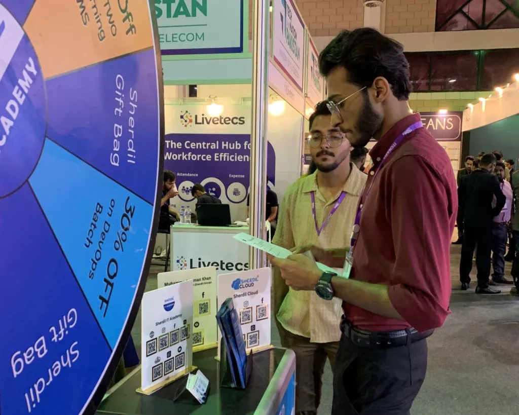 Visitor at the Sherdil gift-bag prize wheel, ITCN Asia 2025