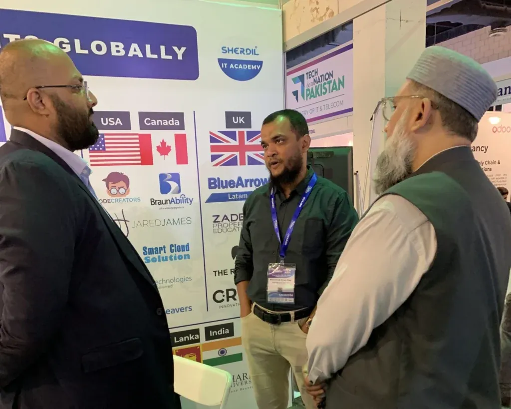 Sherdil team talking with a guest by the Our Clients Globally wall, ITCN Asia 2025