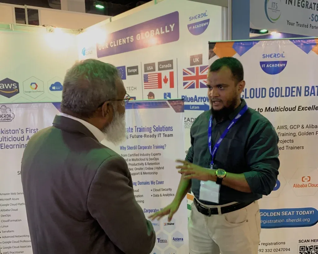 Sherdil team explaining the multicloud batch to a visitor, ITCN Asia 2025 Karachi