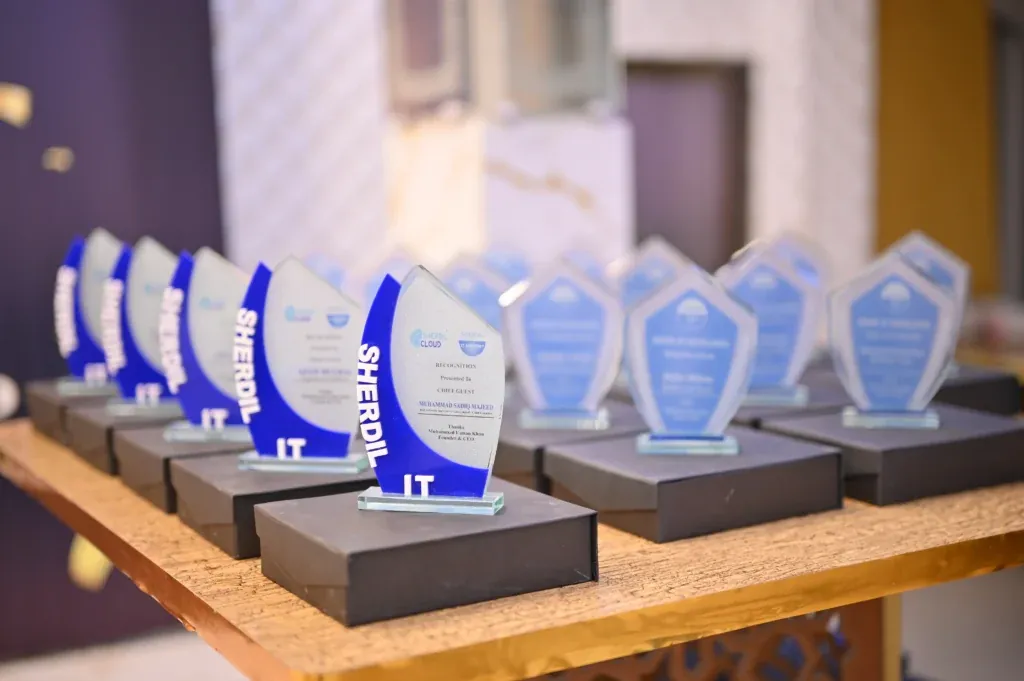 Sherdil IT Academy award shields lined up on a table, 8th Anniversary Students Meetup 2025