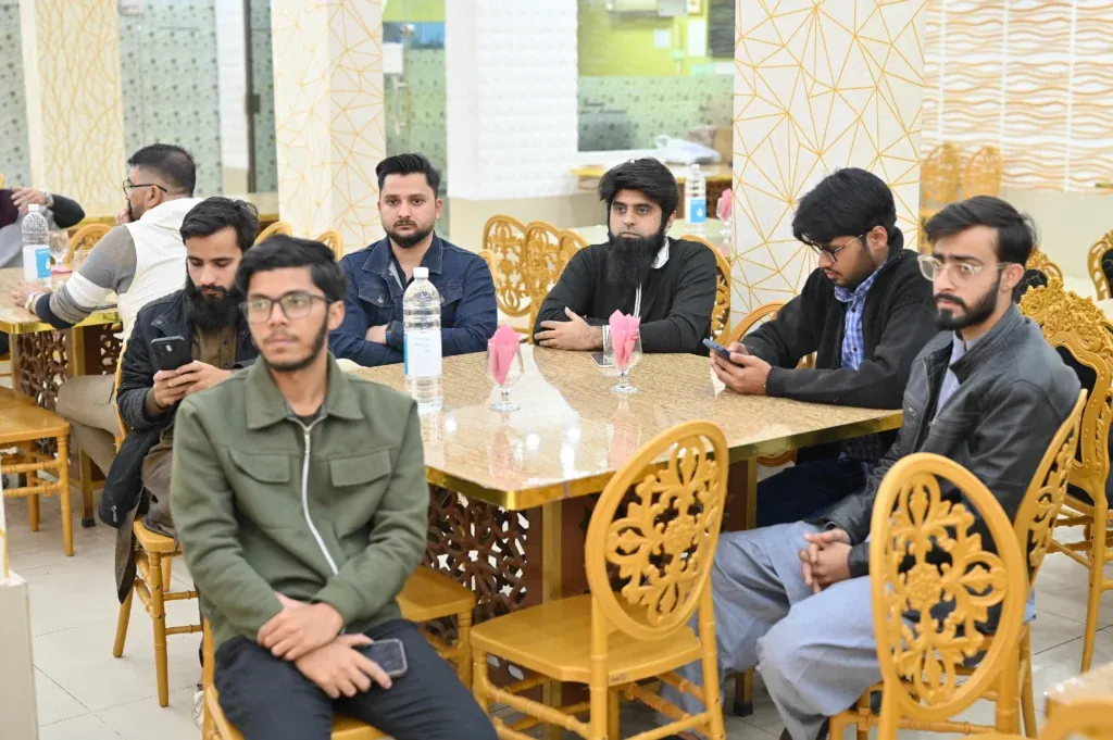 Students and alumni seated at tables, Sherdil 8th anniversary meetup 2025