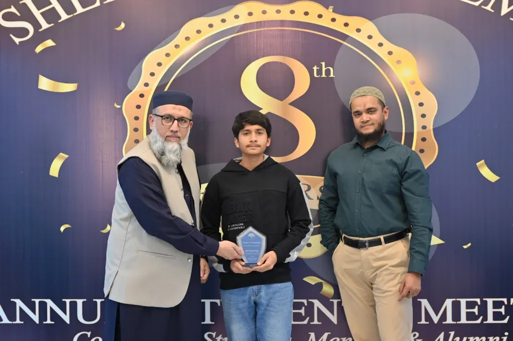 Young student receiving an award at the Sherdil 8th Anniversary Meetup 2025