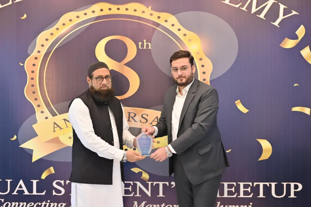 Two men holding an award shield at the Sherdil Annual Students Meetup 2025