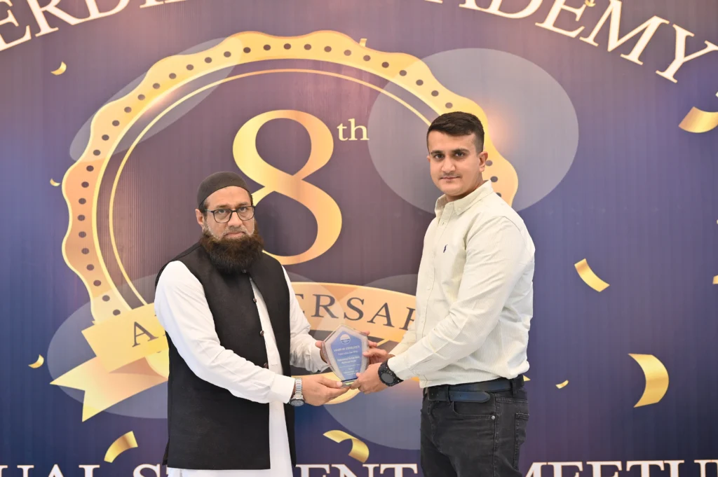 Award handover on stage at the Sherdil IT Academy 8th anniversary, 2025