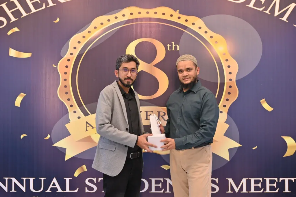 Student holding an award at the Sherdil IT Academy 8th anniversary, 2025