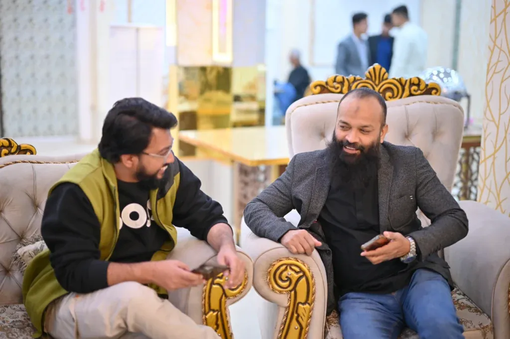 Guests chatting on a sofa at the Sherdil 8th anniversary meetup, 2025