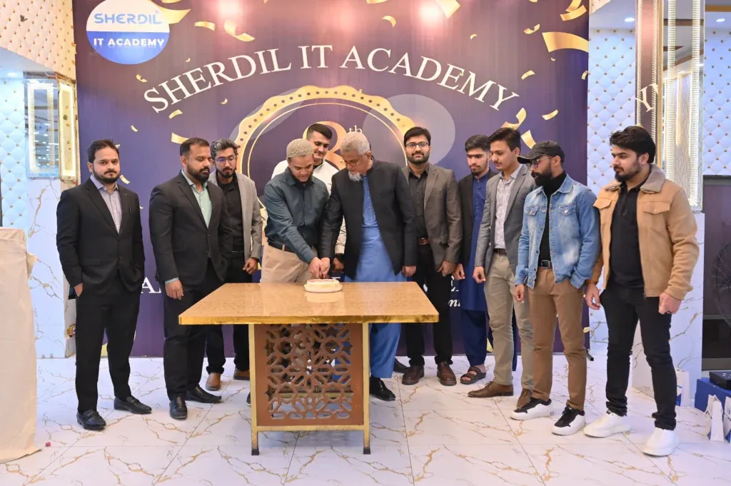Team gathered around the anniversary cake, Sherdil Annual Students Meetup 2025