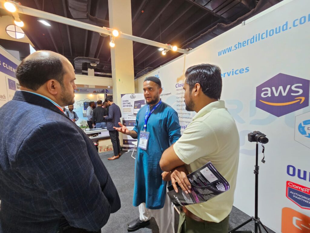 Visitors talking at the Sherdil Cloud stand with AWS signage, ITCN Asia 2026 Karachi