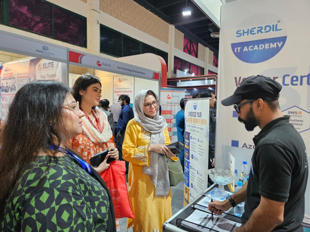 Sherdil IT Academy team member guiding visitors at the booth counter, ITCN Asia 2026