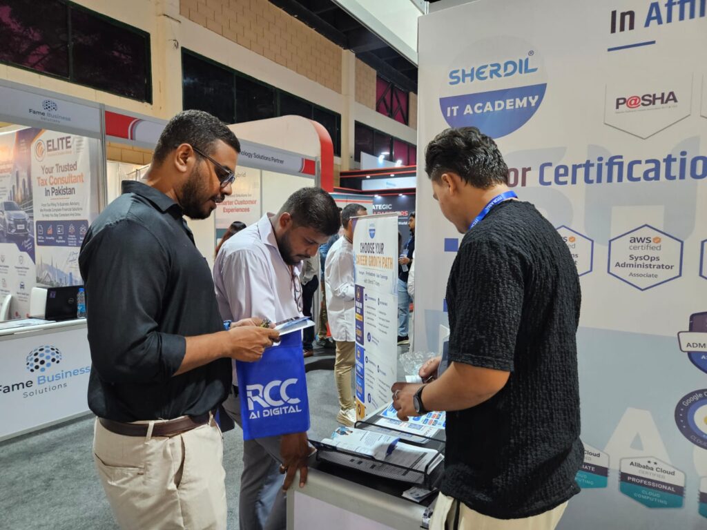 Visitor reading a brochure at the Sherdil certification stand, ITCN Asia 2026 Karachi