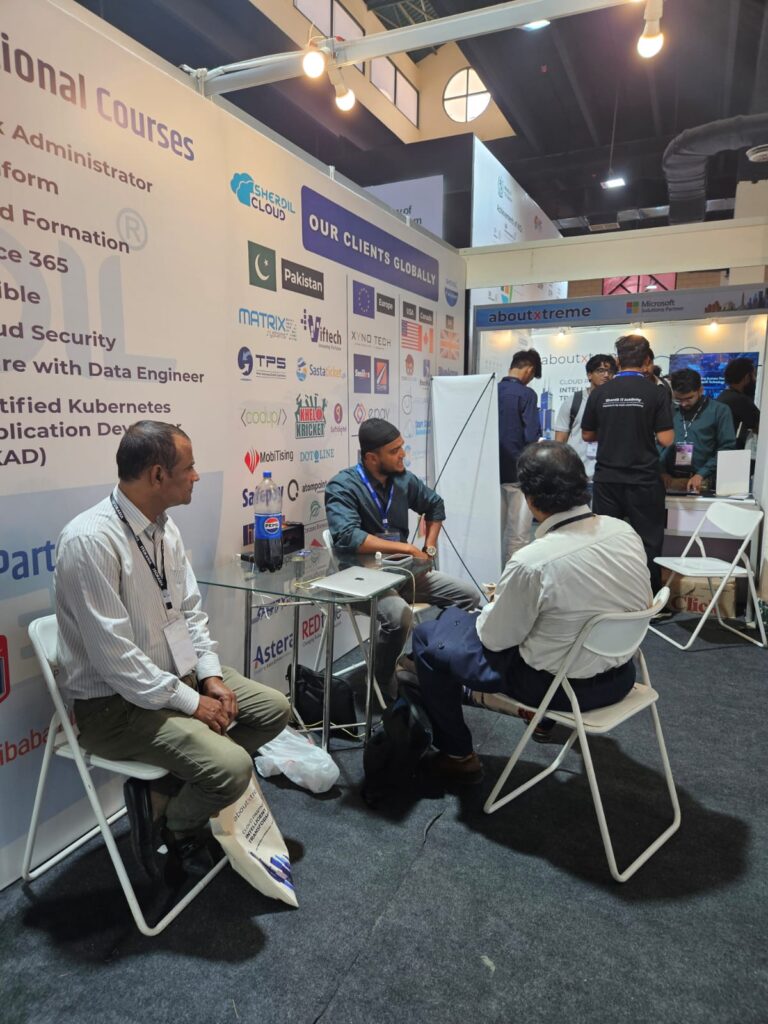 Meeting area of the Sherdil IT Academy booth beside the course list display, ITCN Asia 2026