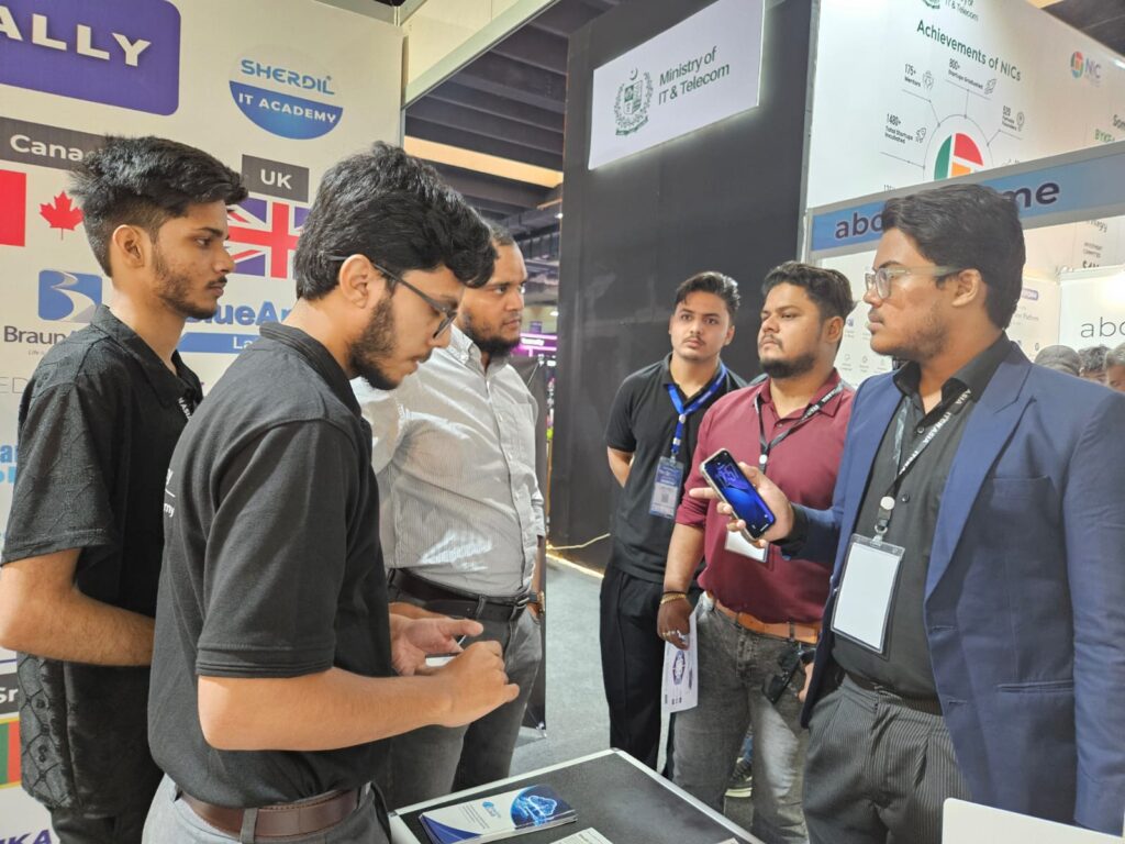 Sherdil team member showing a demo to students at the booth, ITCN Asia 2026